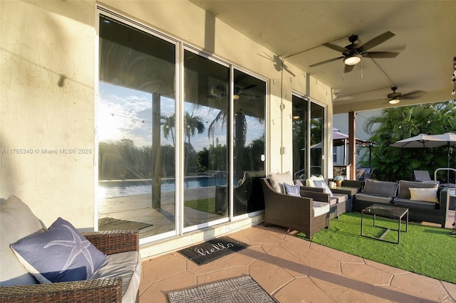 view of patio with ceiling fan and outdoor lounge area