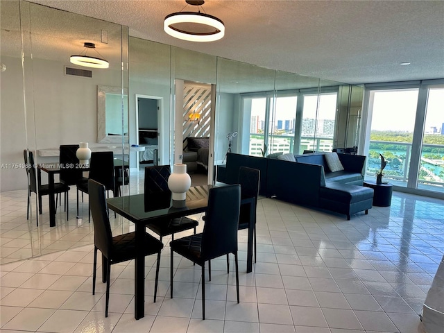 tiled dining area featuring visible vents and a textured ceiling