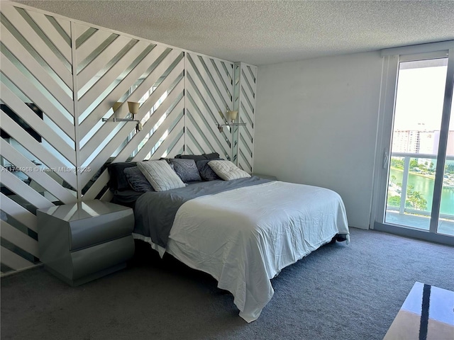 bedroom featuring a textured ceiling and carpet floors