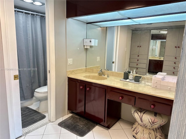 full bathroom with vanity, curtained shower, tile patterned flooring, and toilet