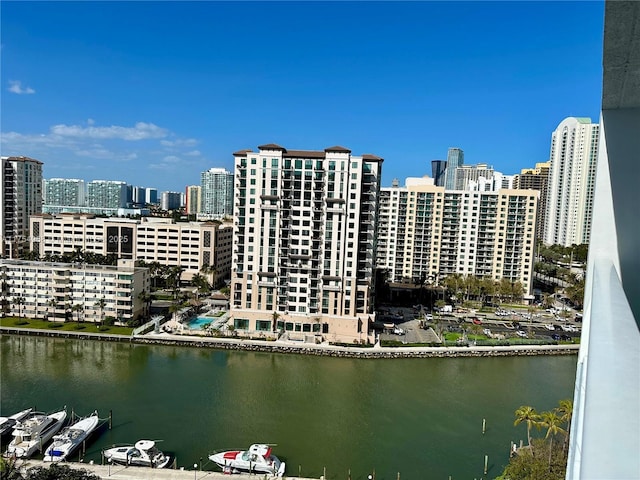 birds eye view of property with a water view and a city view