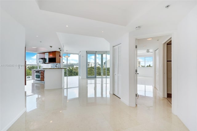 living room with baseboards, marble finish floor, and a wealth of natural light