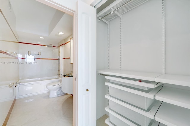 bathroom featuring recessed lighting, toilet, and shower / bathtub combination