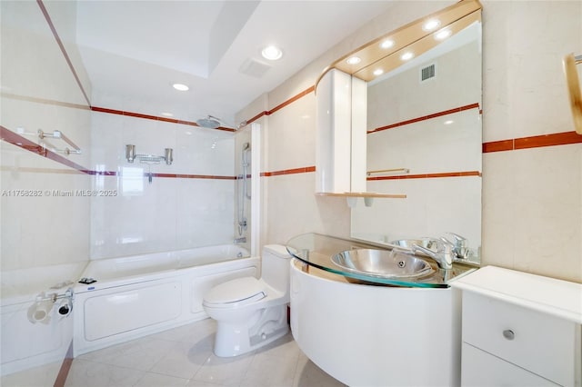 bathroom featuring toilet, tile patterned floors, tub / shower combination, vanity, and recessed lighting