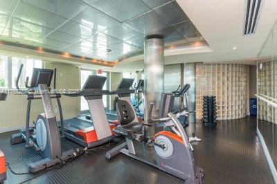 workout area featuring a drop ceiling