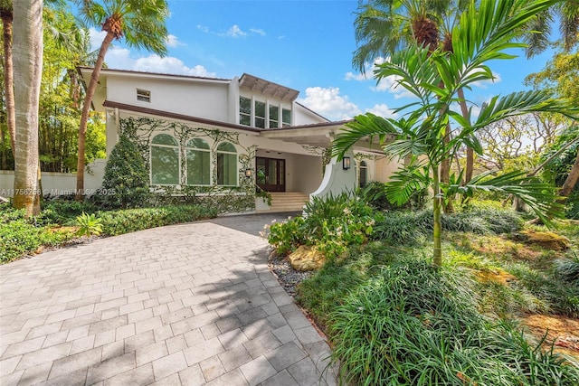 view of front of house featuring decorative driveway and stucco siding