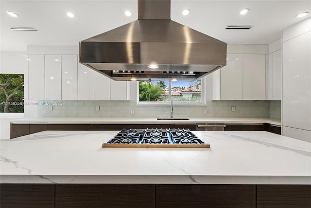 kitchen with white cabinets, modern cabinets, extractor fan, and a sink