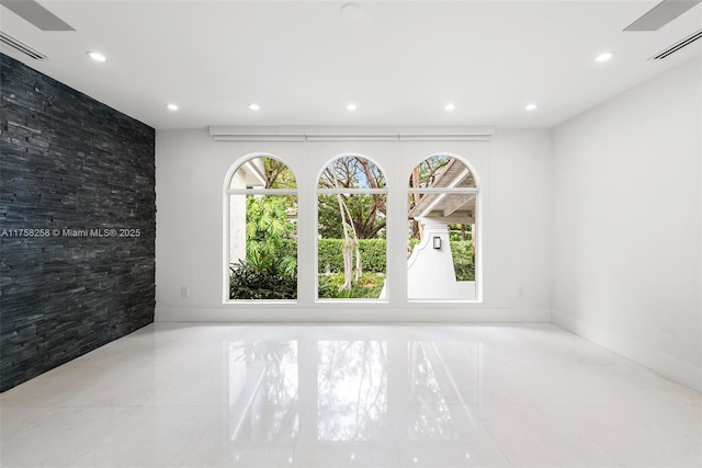 tiled spare room with recessed lighting, visible vents, and a wealth of natural light