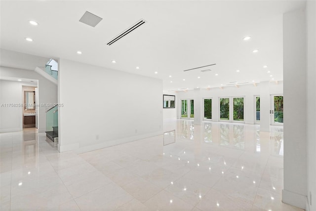 spare room featuring recessed lighting, visible vents, baseboards, and stairs