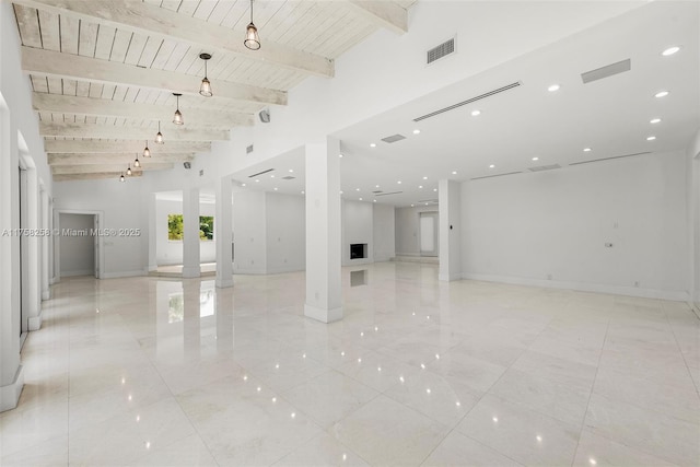 empty room with baseboards, beamed ceiling, wood ceiling, recessed lighting, and ornate columns