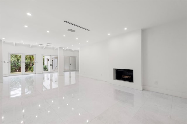 unfurnished living room featuring visible vents, baseboards, a fireplace, recessed lighting, and french doors