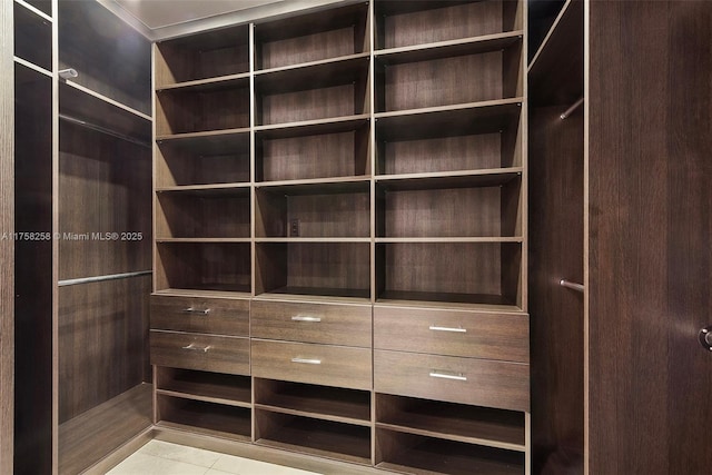 walk in closet featuring tile patterned flooring