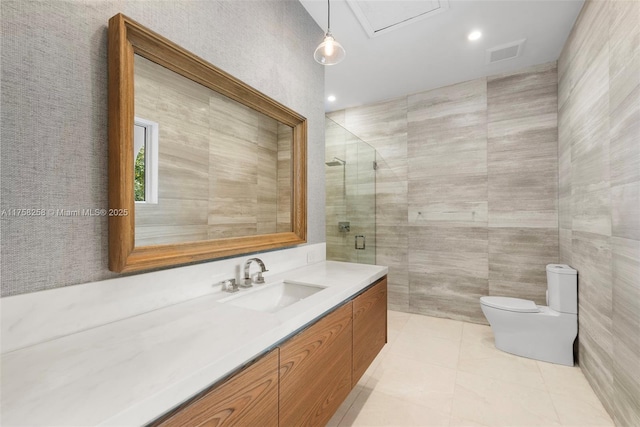 full bath with vanity, a stall shower, tile walls, toilet, and tile patterned floors