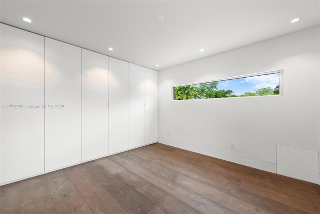 spare room featuring hardwood / wood-style floors and recessed lighting