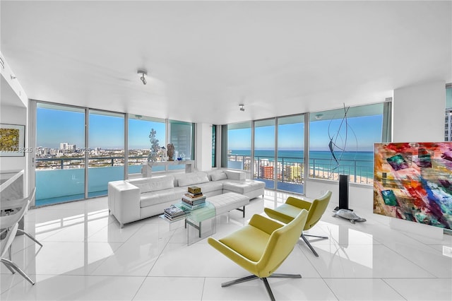 tiled living area with a water view and a wall of windows