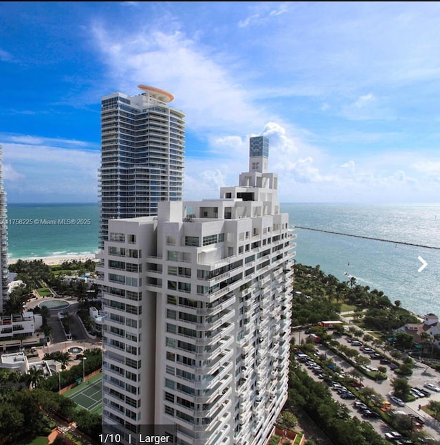 birds eye view of property featuring a water view and a view of city