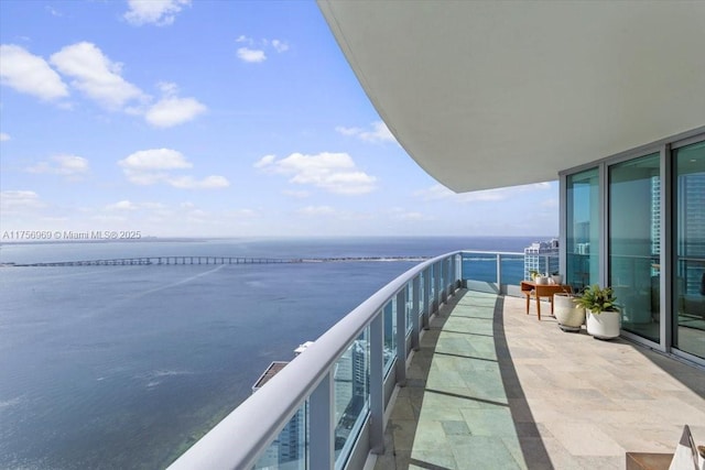 balcony featuring a water view