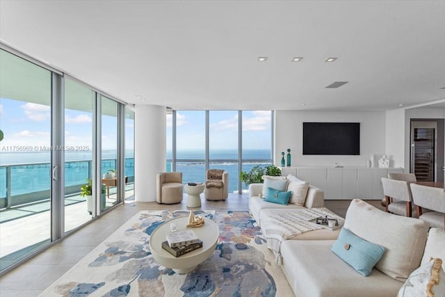 living room featuring a wall of windows and recessed lighting