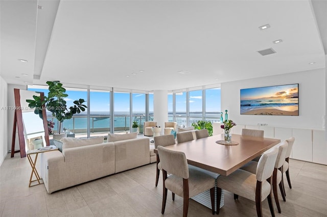 dining area with floor to ceiling windows and recessed lighting