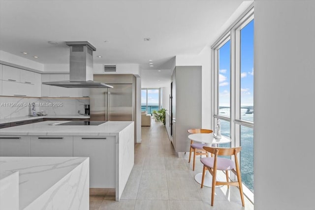 1331 Brickell Bay Dr Unit 4211, Miami, FL 33131 - kitchen featuring modern cabinets, island range hood, stainless steel built in fridge, white cabinets, and healthy amount of natural light