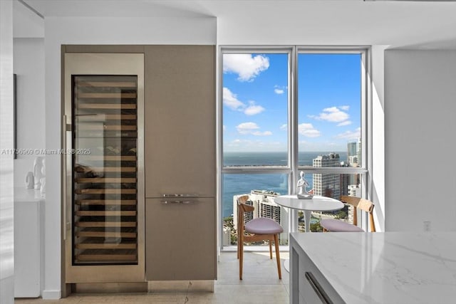 dining room featuring wine cooler and a water view