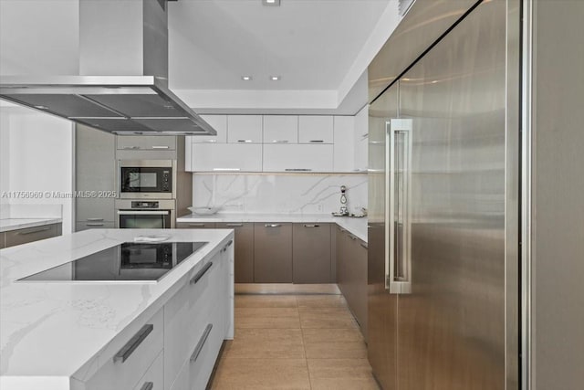 kitchen with white cabinets, wall chimney range hood, modern cabinets, and stainless steel appliances