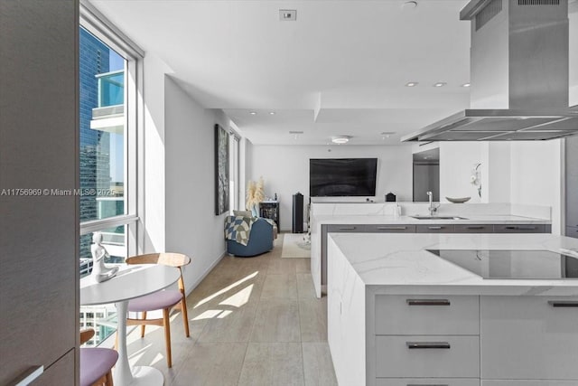 1331 Brickell Bay Dr Unit 4211, Miami, FL 33131 - kitchen featuring island range hood, black electric stovetop, a sink, light stone counters, and modern cabinets