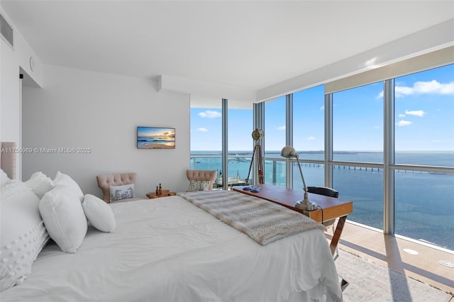 bedroom with expansive windows and visible vents