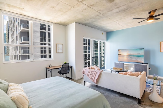 bedroom featuring a ceiling fan, baseboards, and concrete flooring