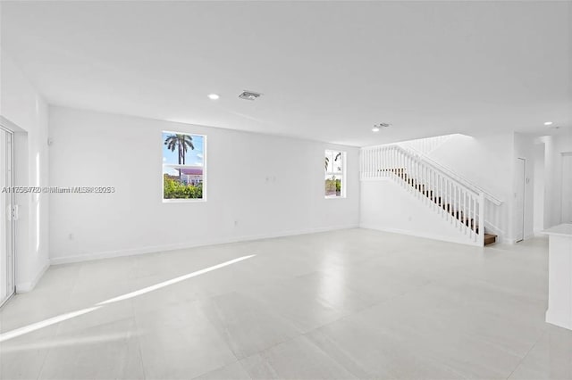 interior space featuring recessed lighting, visible vents, stairway, and baseboards