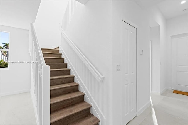 staircase featuring baseboards