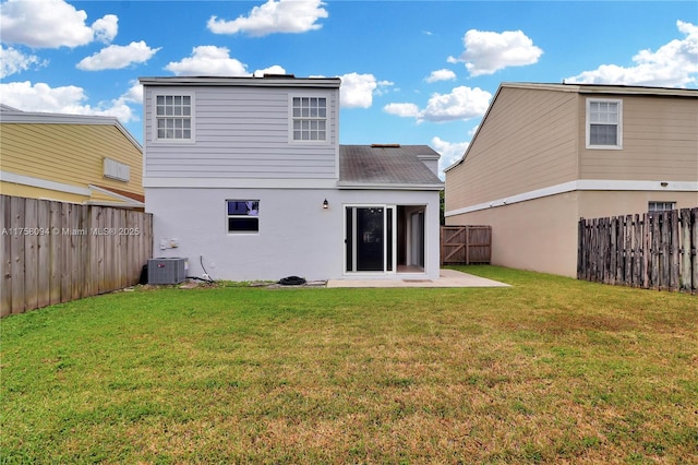 rear view of house with a lawn, cooling unit, stucco siding, a fenced backyard, and a patio