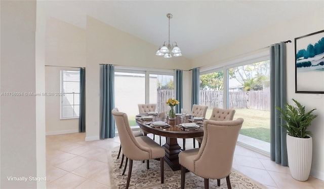 dining area with light tile patterned floors, baseboards, lofted ceiling, and a notable chandelier