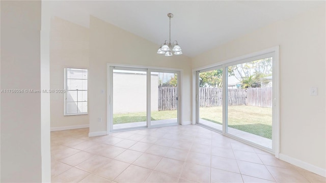 unfurnished room featuring light tile patterned floors, baseboards, high vaulted ceiling, and a chandelier