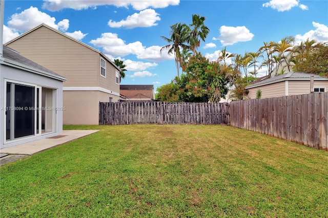 view of yard with a fenced backyard