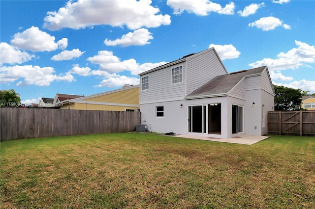 back of property with a patio area, a yard, a fenced backyard, and central AC