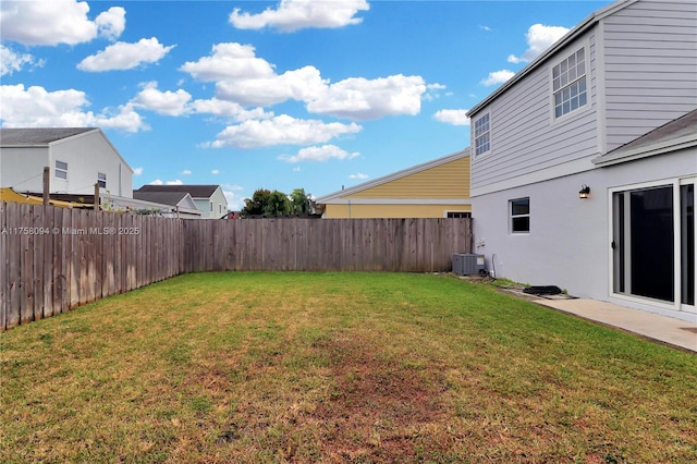 view of yard with central air condition unit and a fenced backyard