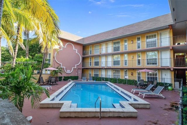 pool featuring a patio area and fence