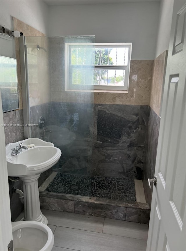 bathroom with a tile shower