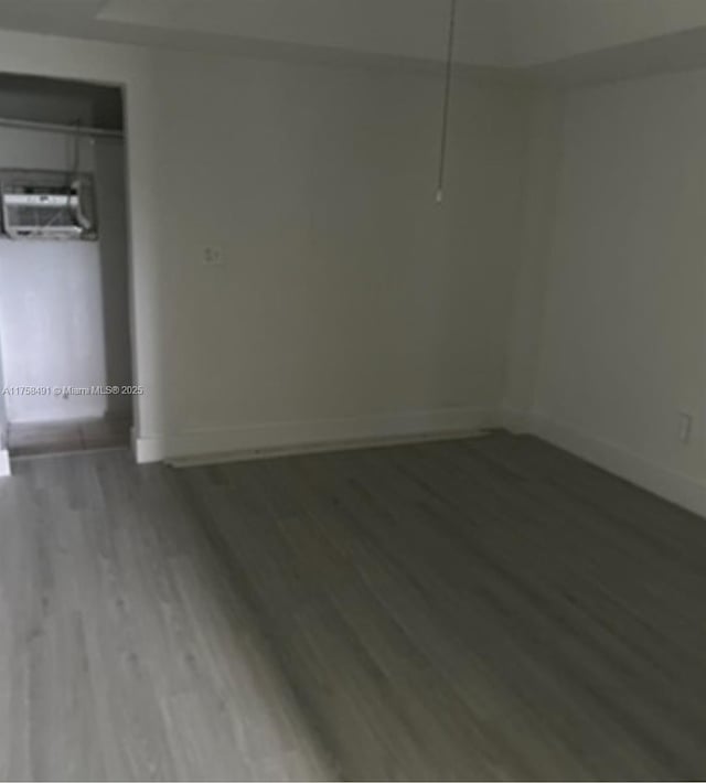 interior space with wood finished floors and baseboards