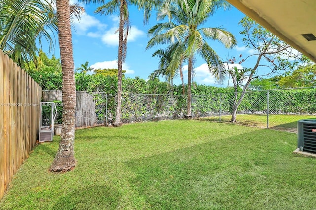 view of yard with cooling unit and a fenced backyard