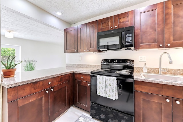 kitchen featuring a sink, a peninsula, black appliances, and a textured ceiling