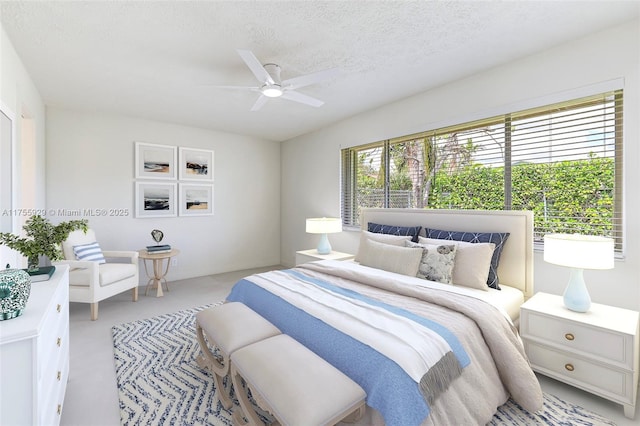 bedroom with ceiling fan and a textured ceiling