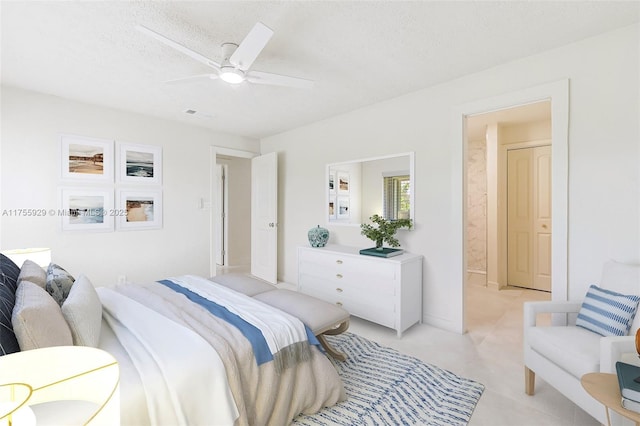 bedroom with a textured ceiling, ceiling fan, and visible vents