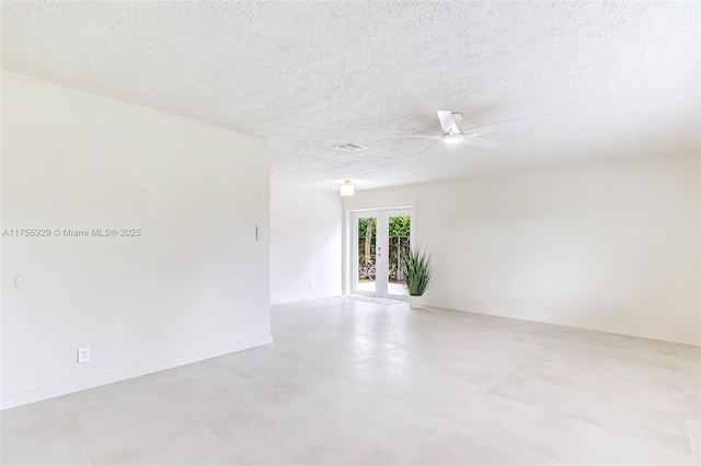 empty room featuring a ceiling fan, french doors, and a textured ceiling