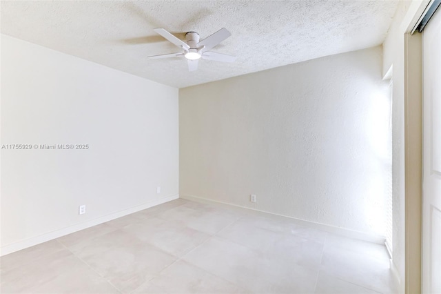 unfurnished room with a textured ceiling, ceiling fan, and baseboards