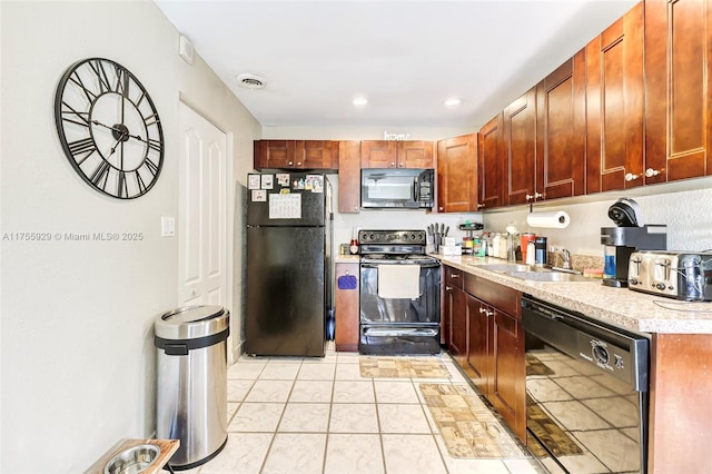 kitchen with light tile patterned floors, visible vents, light countertops, black appliances, and a sink