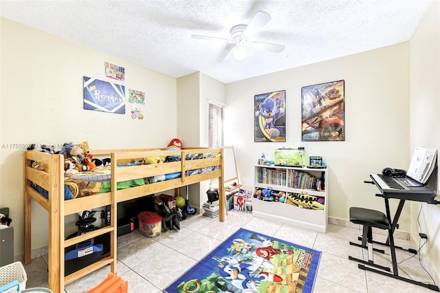 bedroom featuring a ceiling fan, tile patterned flooring, and a textured ceiling