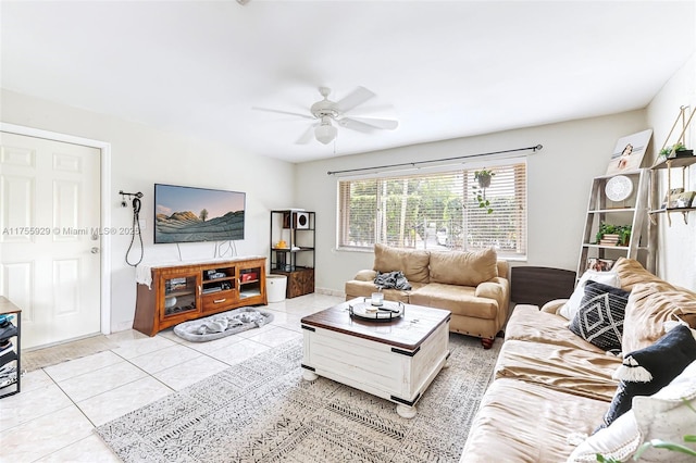 living area with light tile patterned floors and a ceiling fan