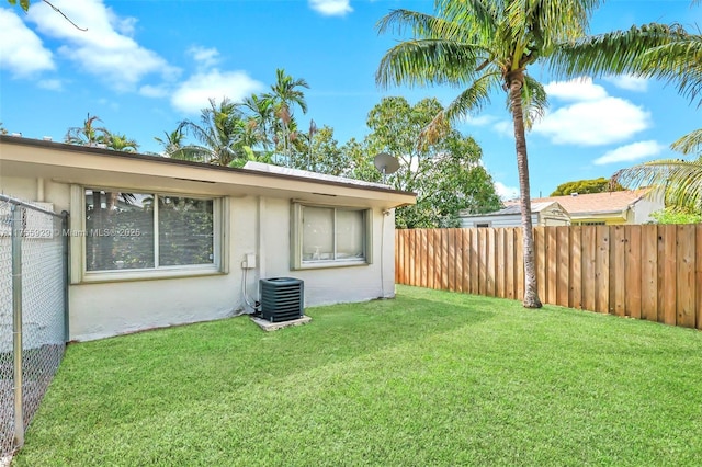 view of yard featuring fence private yard and central air condition unit